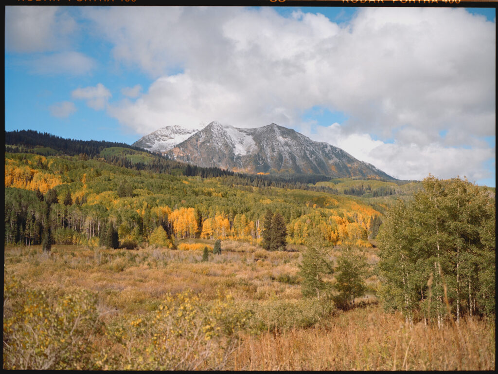 Mt. Beckwith under a bluebird sky with the changing fall colors surrounding it