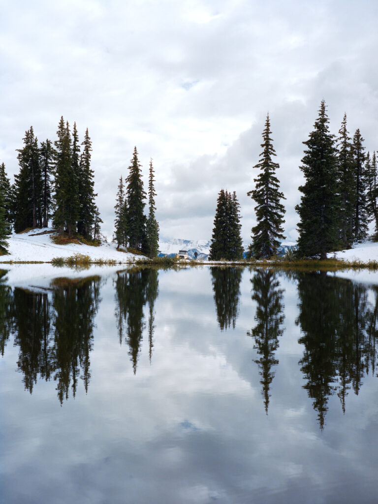 A Toyota 4Runner across a high alpine lake covered in snow